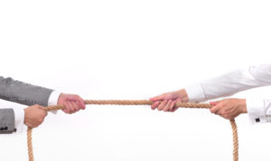 two business men playing tug of war